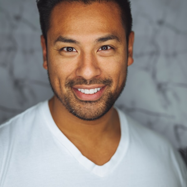 Headshot portrait of a smiling man